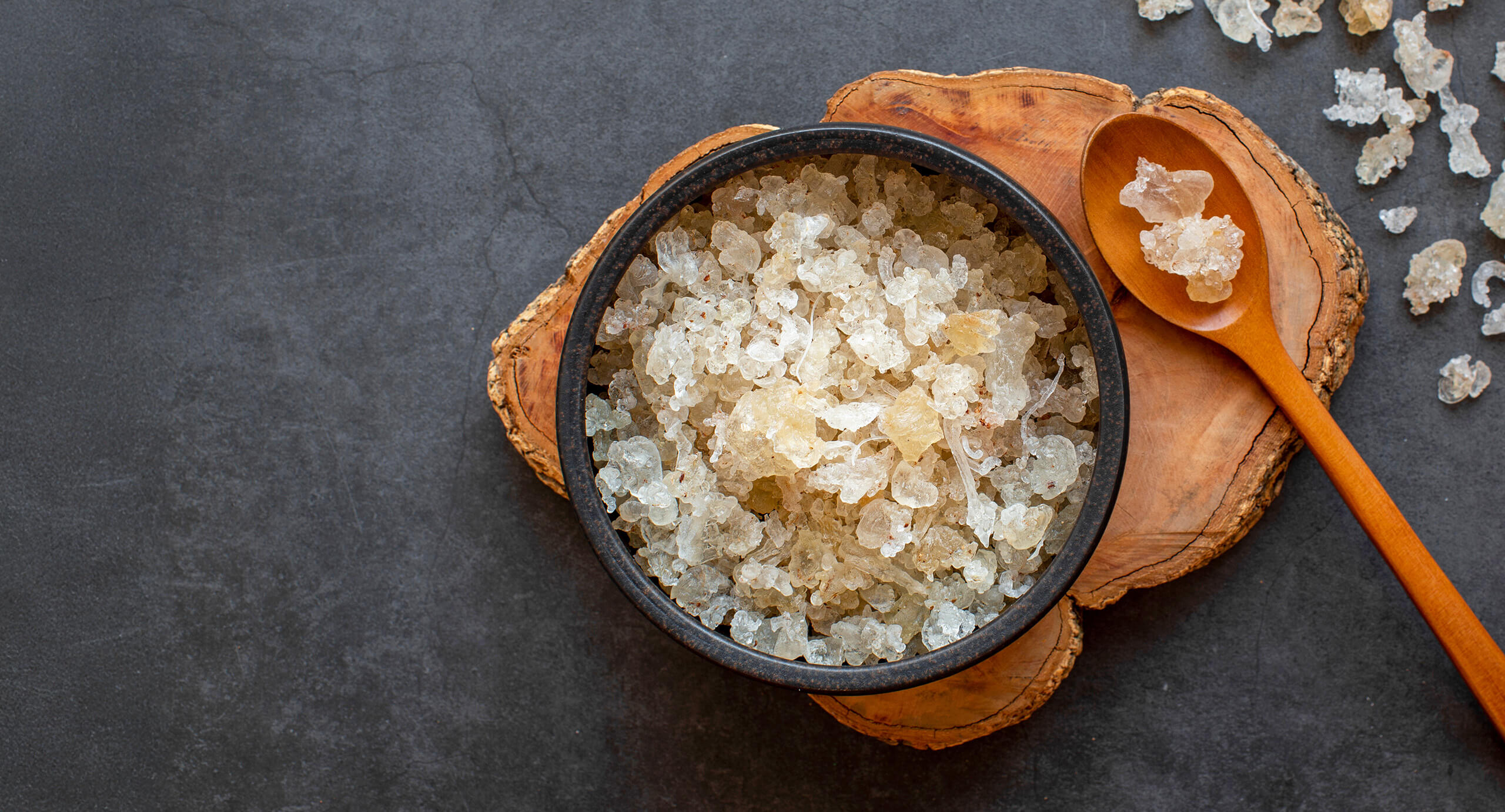 Gum acacia in a bowl with spoon to the side